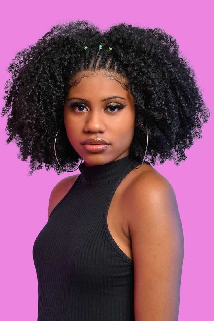 beautiful-black-girl-looking-camera-with-black-hair-wearing-black-dress-isolated-pink-backgrou_309823-354